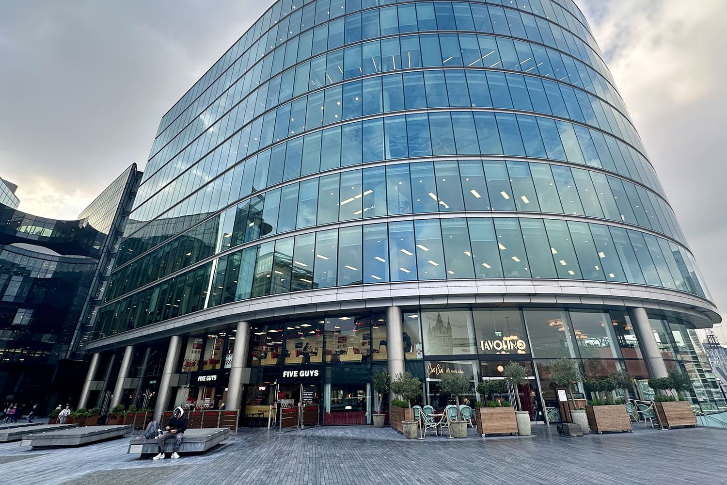 A modern commercial office building with food outlets on the ground floor, in Southwark, London